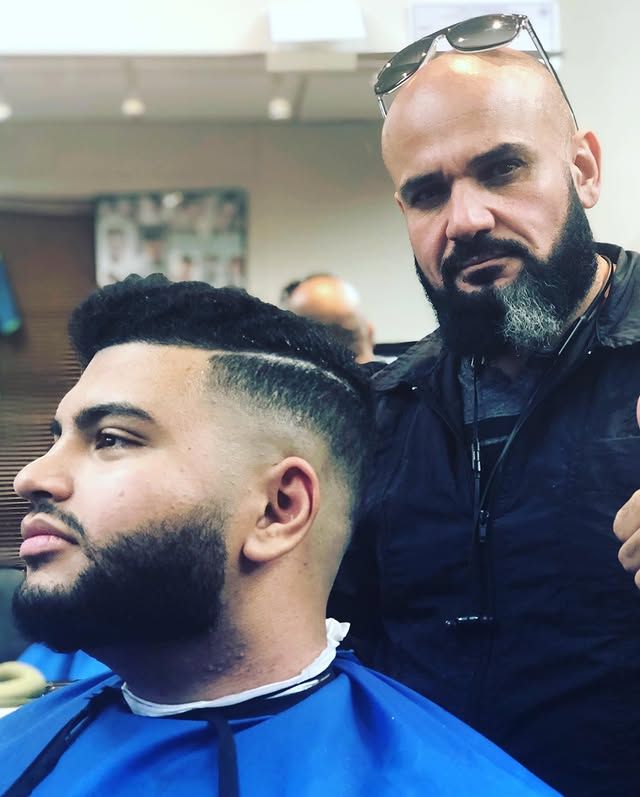 Nathan with a client after a skin fade and beard line-up at Nathan's Barbershop in Seattle